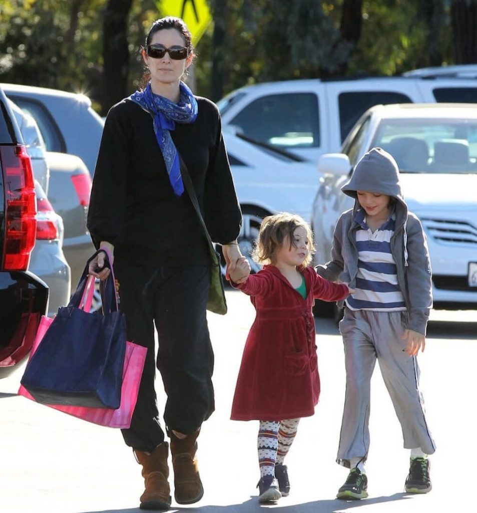 Carrie-Anne Moss walking with two kids