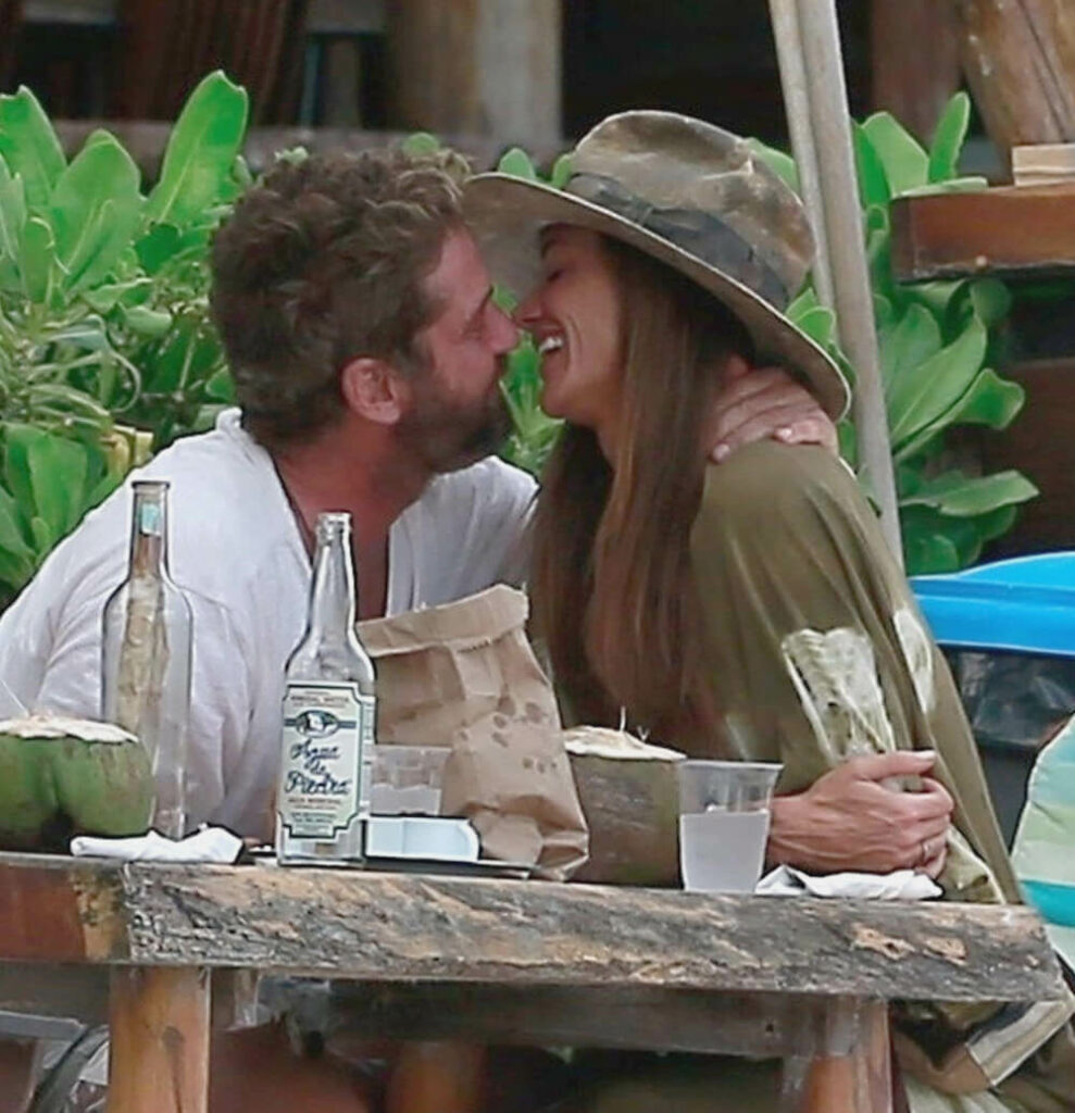 Gerard Butler and Morgan Brown kissing