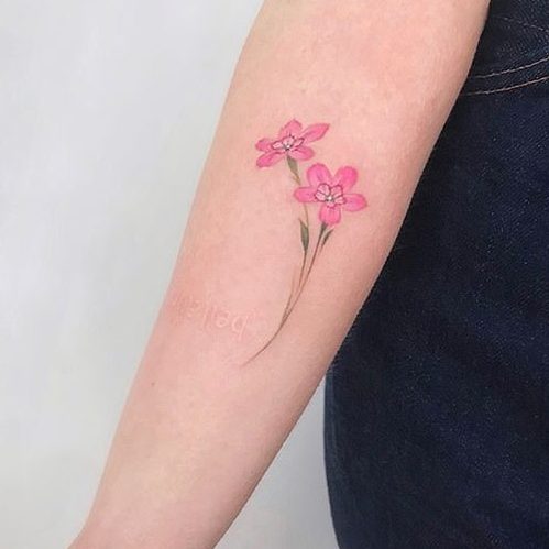 January Jones pink flower tattoo