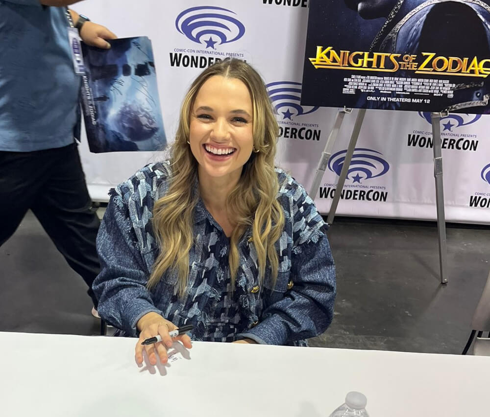 Madison Iseman is giving autographs