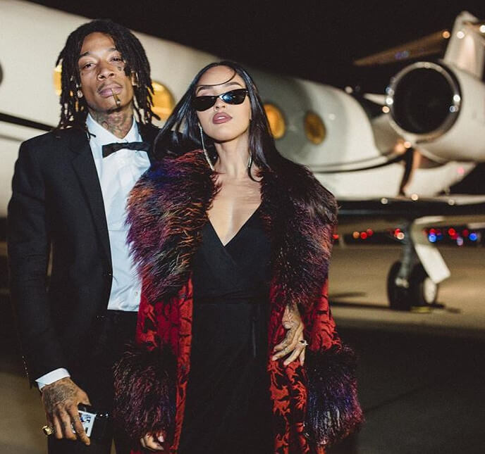 Wiz Khalifa and Izabela Guedes near the plane